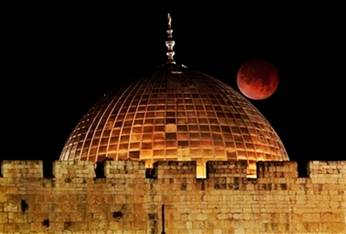 The Moon glows orange as it is seen above the Dome of the Rock ...